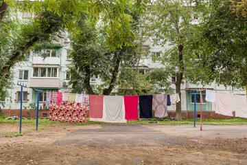 Laundry dries on the rope in courtyard of Khrushchyovka. Khrushchyovka is common type of old low-cost apartment building in Russia and post-Soviet space. Household concept. Russia, Vladivostok.