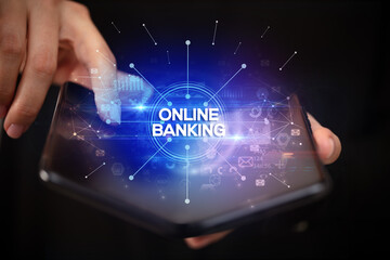 Naklejka premium Businessman holding a foldable smartphone, new business concept