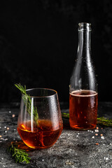 Red low alcohol drink, chilled colorful beverages on rustic black background. summer party. Alcoholic drink concept. Freeze motion, drops in liquid splash