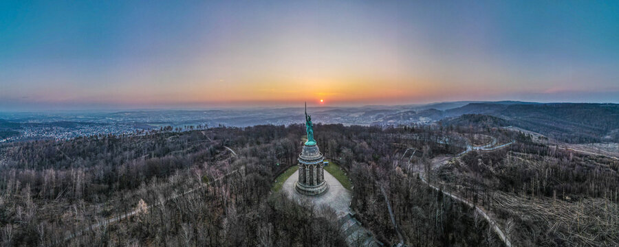 Panoramic view of the Hermannsdenkmal monument on a hill at the sunset in Detmold, Germany