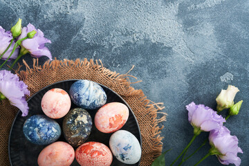 Easter eggs. Dyed Easter eggs with marble stone effect ref and blue color in rustic style on dark ...