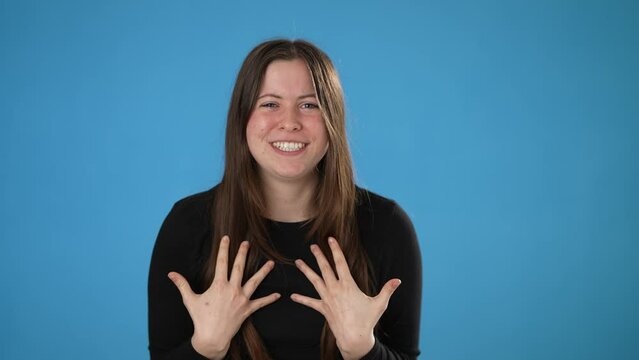 Angry, scared brunette young woman 20s posing isolated on blue background studio. People lifestyle concept. Spreading arms screaming crying ask why