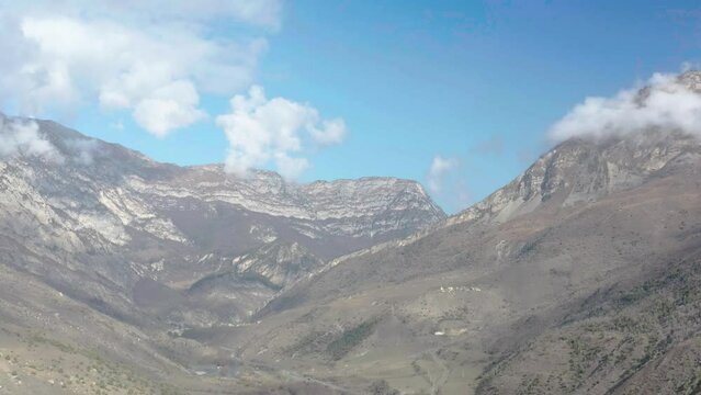 Drone flying along mountain slopes in sunny autumn day, Fiagdon gorge, Northern Ossetia - Alania, Caucasus, Russia
