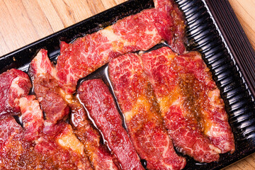 Raw pork on plate, Korean traditional style fresh pork beef belly BBQ, Japanese meat hot pot or Shabu in the restaurant, barbecue food