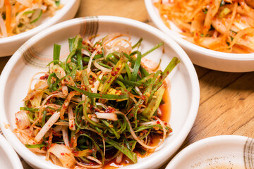 Spicy Kimchi. Korean pickle or Pickled radish vegetables and seasoning on bowl on wood table background, Japanese food
