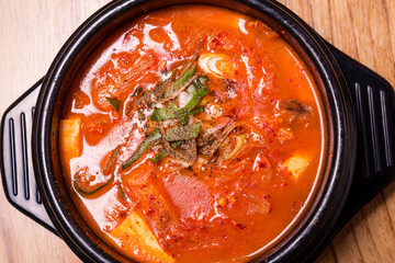 Kimchi soup in hot black iron pot, Korean traditional Kimchi Jjigae soup in bowl in the restaurant, Japanese hot pot food