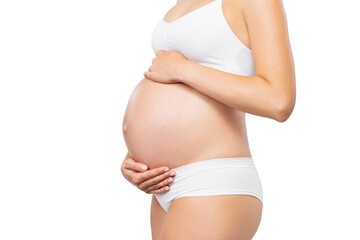 Young pregnant woman in swimsuit. Girl expecting a baby and touching her belly isolated on white background. Close-up image.