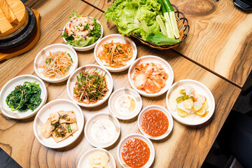 Spicy Kimchi group. Korean pickle or Pickled radish vegetables and seasoning on bowl on wood table background, Japanese food