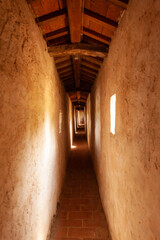 Obraz premium Long narrow corridor in city wall with loopholes