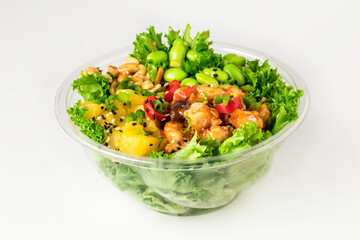 Poke bowl with chicken in a sweet sauce, salad leafs, edamame beans, parsley, pineapple and peanuts on a white background. Sweet chili sauce and pineapple slices. Copy space. Close up