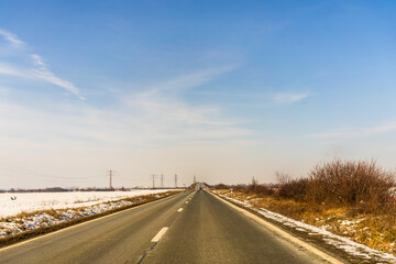 Highway surrounded by snowy fields in Bucharest, Romania