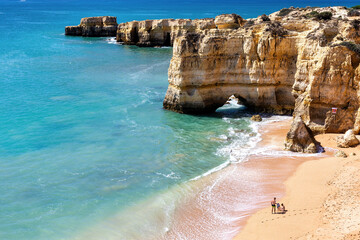 View of cliffs and ocean in Praia da Mare das Porcas beach in Algarve, Portugal.