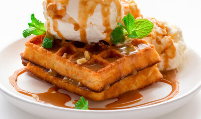 dessert. waffles with caramel syrup, ice cream and fresh mint close-up