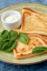 tasty breakfast with pancakes and herbs