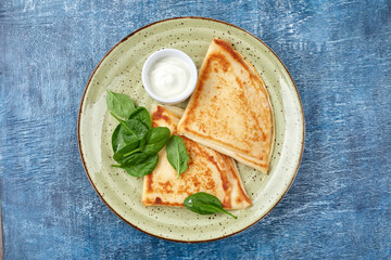 tasty breakfast with pancakes and herbs