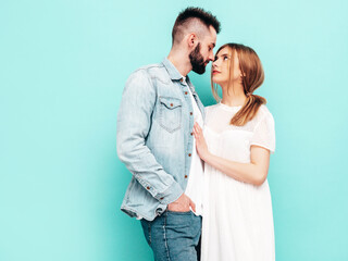 Sexy smiling beautiful woman and her handsome boyfriend. Happy cheerful family having tender moments near blue wall in studio.Pure cheerful models hugging.Embracing each other. Cheerful and happy