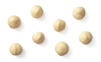 Unshelled macadamia nuts isolated on white background, top view. - obrazy, fototapety, plakaty