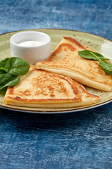 tasty breakfast with pancakes and herbs