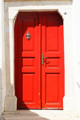 the old and solid doors in painted wood are one of the charms of the Cyclades, in the heart of the Aegean Sea, here on the island of Tinos in the famous white village of the marble craftsmen of Pyrgos