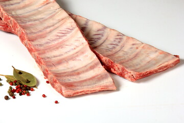 Raw Pork ribs with a spices isolated on white