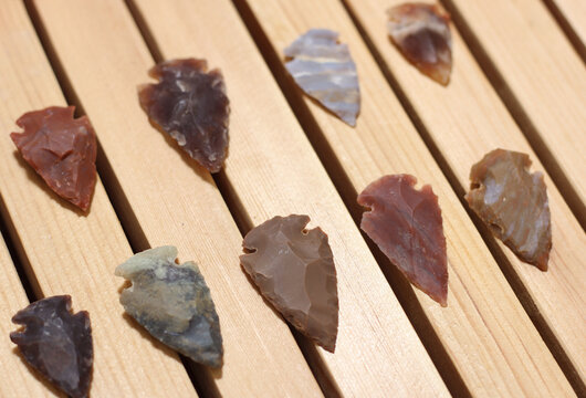 Closeup of the native American arrowhead collection on wooden display.