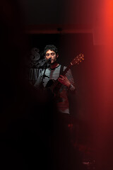 Musician playing guitar during a concert