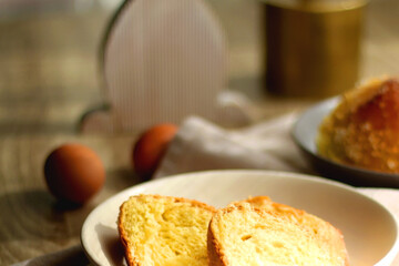Plate of traditional sweet bread, eaten at Easter time in Croatia. Easter bunny, eggs and flowers on the table. Selective focus.