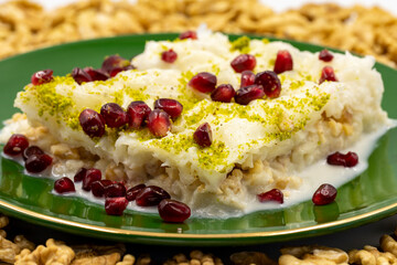 Gullac dessert. Traditional Turkish dessert sprinkled with walnuts. Gullac is a dessert made with milk. close up