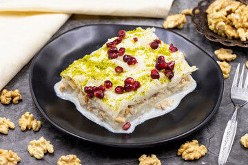 Gullac dessert ( milk dessert ) on a dark background. Traditional Turkish dessert. close up