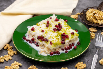 Gullac dessert ( milk dessert ) on a dark background. Traditional Turkish dessert. close up