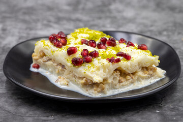 Gullac dessert ( milk dessert ) on a dark background. Traditional Turkish dessert. close up
