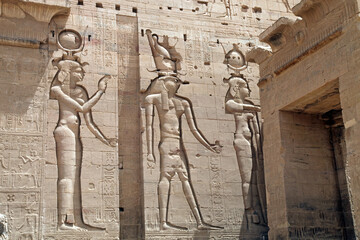 Carved wall reliefs of Isis and Horus at the Temple of Philae, Aswan Egypt
