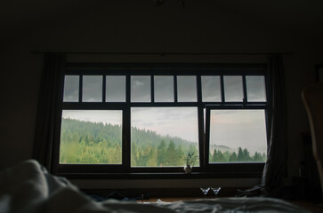 beautiful view of the mountains from the room on vacation in an early foggy morning