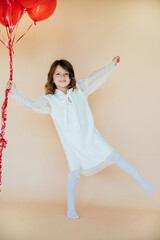 Cute little girl with heart shaped balloons on Valentine's day. family, love. gifts for the holiday.