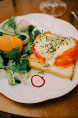Morning breakfast with fresh toast with salmon and vegetables. Healthy food concept.