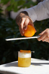 Bartender making alcoholic cocktail at table, outdoor
