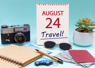 Travel planning, vacation trip - Calendar with the date 24 August glasses notepad pen camera cash passports.