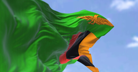 Detail of the national flag of Zambia waving in the wind on a clear day.
