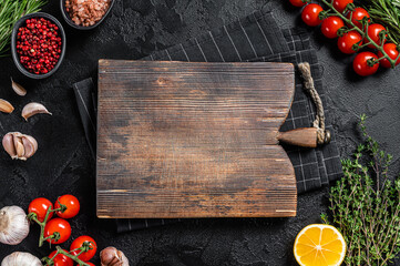 Ingredients for cooking and empty cutting board on old wooden table, Food cooking and healthy eating background. Black background. Top view. Copy space