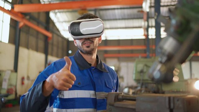 Engineer wearing virtual reality headset standing in the manufacturing factory. Moving hand and looking around the data. Working with Holographic Animations. High technology and industrial concept