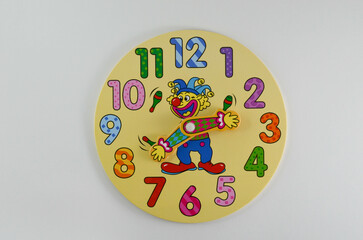 children's educational clock with numbers and hands on a white background