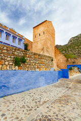 Chefchaouen, blue city. View on medieval stone city walls and the gate tower. Chefchaouen,...