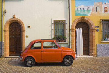 Red Fiat 500 D in San Giuliano district in Old Town of Rimini - obrazy, fototapety, plakaty