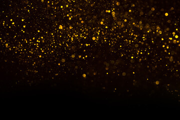 Abstract background of shiny golden glitter particles  lights bokeh
