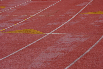 The red pavement and the starting grid for runners on a High School track