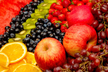 Naklejka na ściany i meble Fresh fruits concept, Arrangement of kiwi orange apple and assorted burry as background