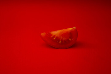 Red tomato on a red background