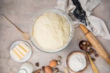 Beat flour and kitchen utensils, a baking dish, a rolling pin with eggs on the table. Baking, cooking concept. Chef making bread and gingerbread cookies. The cook kneads and rolls the dough.