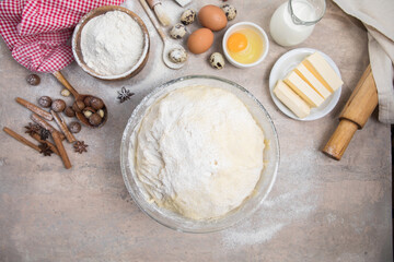 Beat flour and kitchen utensils, a baking dish, a rolling pin with eggs on the table. Baking, cooking concept. Chef making bread and gingerbread cookies. The cook kneads and rolls the dough.