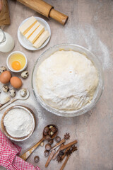 Beat flour and kitchen utensils, a baking dish, a rolling pin with eggs on the table. Baking, cooking concept. Chef making bread and gingerbread cookies. The cook kneads and rolls the dough.